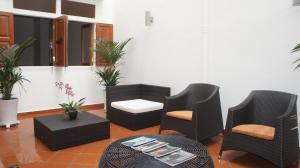 a group of chairs and tables in a room at Heeren Straits Hotel in Malacca