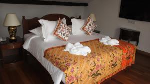 a hotel room with a bed with towels on it at Heeren Straits Hotel in Malacca