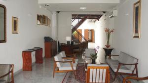 a living room with a bunch of chairs and a table at Heeren Straits Hotel in Malacca