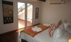 a bedroom with a bed with towels on it at Heeren Straits Hotel in Malacca