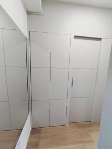 a room with white cabinets and a door at Studio SUPER LUXO a 5 min do Nubank Parque in São Paulo