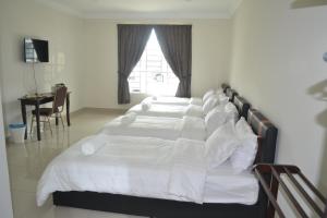 Postel nebo postele na pokoji v ubytování Hotel Mutiara KGMMB, Melaka