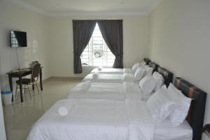 Postel nebo postele na pokoji v ubytování Hotel Mutiara KGMMB, Melaka