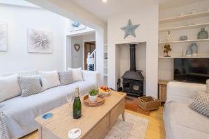 a living room with a couch and a table at 67 Pebble Cottage in Aldeburgh