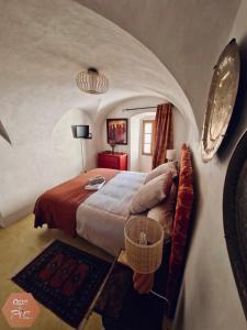 a bedroom with a large bed in a room at Casa di Pia, demeure Corse du XIXème in Olmeta-di-Tuda