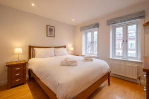 a bedroom with a bed with two towels on it at 67 Pebble Cottage in Aldeburgh