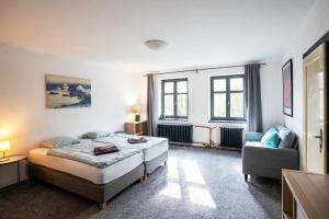 a bedroom with a bed and a chair at Vila Republika in Malá Skála +7 photos