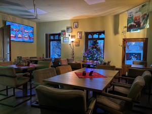 a restaurant with tables and chairs and a christmas tree at LeClub in Târgu-Mureş