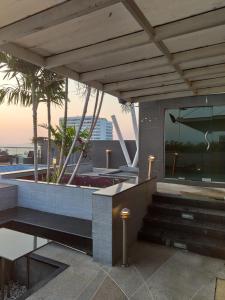 a view of a building with a pool and stairs at The Gallery Condominium B in Jomtien Beach
