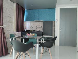 a kitchen with a table and chairs in a room at The Gallery Condominium B in Jomtien Beach
