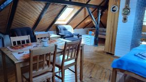 a dining room with a table and chairs in a attic at Willa Sielsko Anielsko in Szklarska Poręba