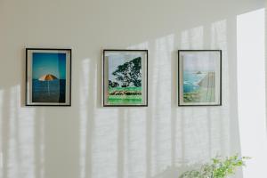 four framed photographs on a white wall at Skyone Lux 2Bed room Aprt in BoxHill with car park in Box Hill