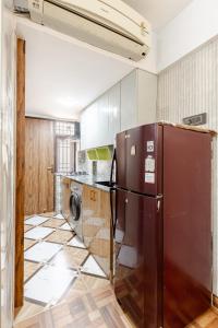 a kitchen with a refrigerator in the middle at Super Luxury Independent Studio in Gurgaon