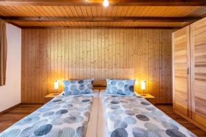 a bedroom with a bed with two lamps on both sides at Beierleshof in Hinterschollach +51 photos
