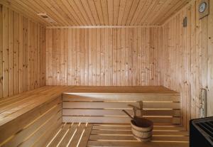 a wooden sauna with a bucket in it at Leonardo Boutique Hotel Larnaca in Larnaca
