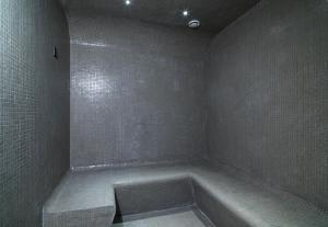 a bathroom with a bath tub in the corner at Leonardo Boutique Hotel Larnaca in Larnaca