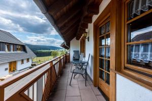 a balcony with a table and chairs on it at Beierleshof in Hinterschollach