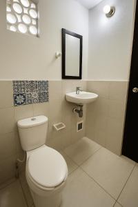 a bathroom with a toilet and a sink at Estudio privado cerca a la playa in Palomino