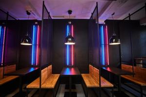 a room with wooden benches and colorful lights at Gent-cosy-stay in Ghent