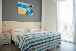 Posteľ alebo postele v izbe v ubytovaní Residence Rimini Mare