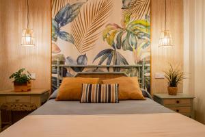 a bedroom with a bed with a painting on the wall at Amazonia in Coslada