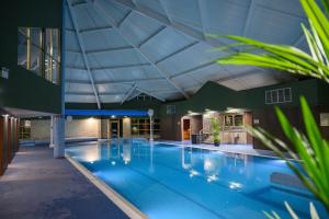 a large indoor swimming pool with a large ceiling at Newtown Park Hotel in Wexford