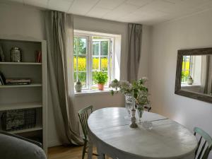 a dining room with a table and a window at Towerhouse Apartment in Ystad
