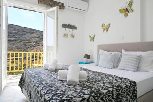 a bedroom with a bed with a view of the ocean at Terramare Villa's 3 in Kithnos