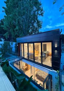 a black house with a large glass window at Chic 2 Bedroom Modern Cave House in London