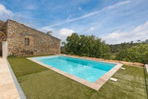 an image of a swimming pool in front of a house at La Bergerie in Esparron