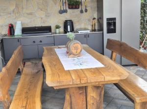 a wooden table with two benches in a kitchen at Villa Lemily in Matulji