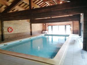 a large swimming pool in a building with at Châlet CARIBOU 74 avec Piscine Chauffée in Morillon