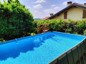 a large blue swimming pool in a yard at IseoLakeRental - Casa Glicine in Sarnico