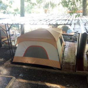 a tent sitting on the ground in the rain at Cabin rahong riverside in Palayangan