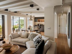a living room with a couch and a table at Villa Coste Simon's Town in Simonʼs Town
