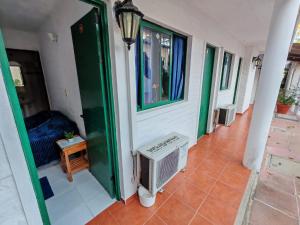a hallway of a house with a window and a heater at Hostel Colibri Colonia in Colonia del Sacramento