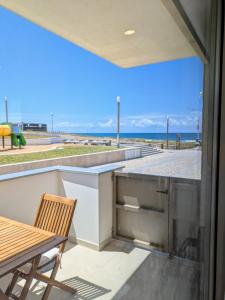 a view of the ocean from the balcony of a house at Paredes da Vitória - Surf & Sun in Pataias