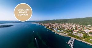 an aerial view of a town on the water at Falkensteiner Hotel Park Punat in Punat