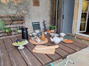 a wooden table with plates of food on it at domaine de Capoulade in Narbonne