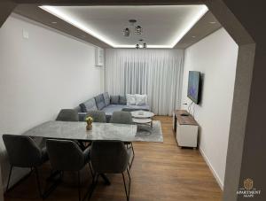 a living room with a table and a couch at Apartment Agape in Posušje