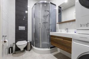 a bathroom with a shower and a toilet and a sink at Magnificent Diamond Duplex in Tbilisi City +105 photos