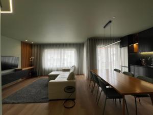 a living room with a couch and a table and chairs at Casa de Lencastre in Viana do Castelo