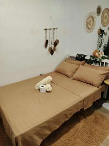 a bedroom with a bed with two towels on it at Home in Pagadian City near airport in Norte