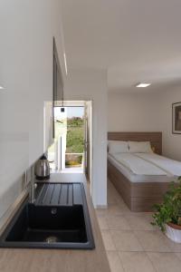 a bathroom with a sink and a bed in a room at Apartment Vegas in Novalja +86 photos