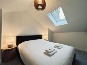 une chambre avec un lit avec des serviettes dessus dans l'établissement 2 Clairmarais T2 en duplex proche gare centre, à Reims