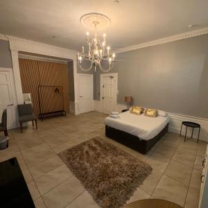 a bedroom with a bed and a chandelier at Spacious Double Room In The Heart Of Edinburgh in Edinburgh