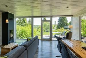 a living room with couches and a wooden table at 4 Personen mit Sauna F4H0 in Ruhla