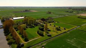 an aerial view of a park with trees and a river at Pean-buiten Weidum in Weidum