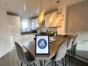 a kitchen with a dining room table and chairs at Ruby Place by Blue Skies Stays in Hartlepool +11 photos