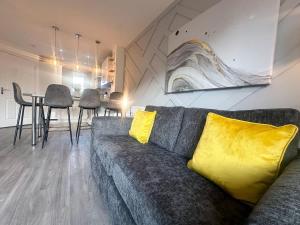 a living room with a couch and a table with chairs at Ruby Place by Blue Skies Stays in Hartlepool